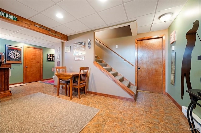 101 Pinehurst Ln, Augusta, NY 13425 - dining area featuring a paneled ceiling, baseboards, baseboard heating, and stairs