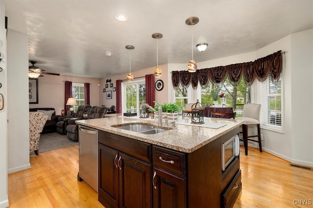 101 Pinehurst Ln, Augusta, NY 13425 - kitchen with a sink, stainless steel appliances, light wood-style flooring, decorative light fixtures, and dark brown cabinetry