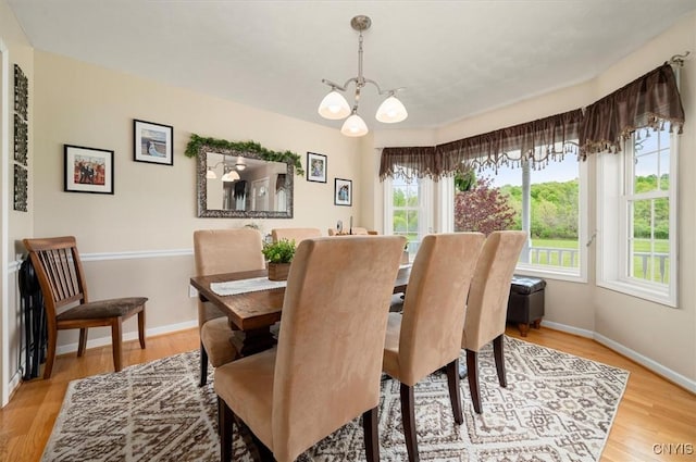 101 Pinehurst Ln, Augusta, NY 13425 - dining room featuring a chandelier, baseboards, and wood finished floors