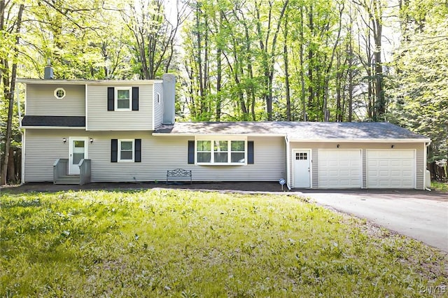 view of front of property with a garage, a chimney, asphalt driveway, a front yard, and entry steps