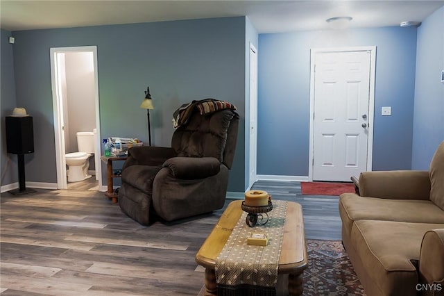 living room featuring wood finished floors and baseboards