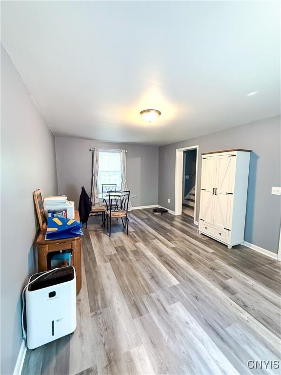 rec room featuring wood finished floors and baseboards