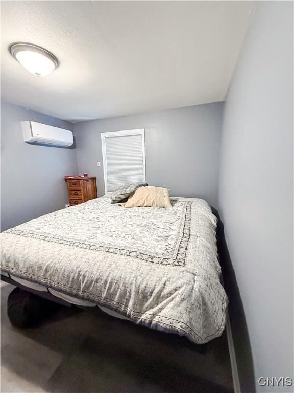 bedroom with an AC wall unit