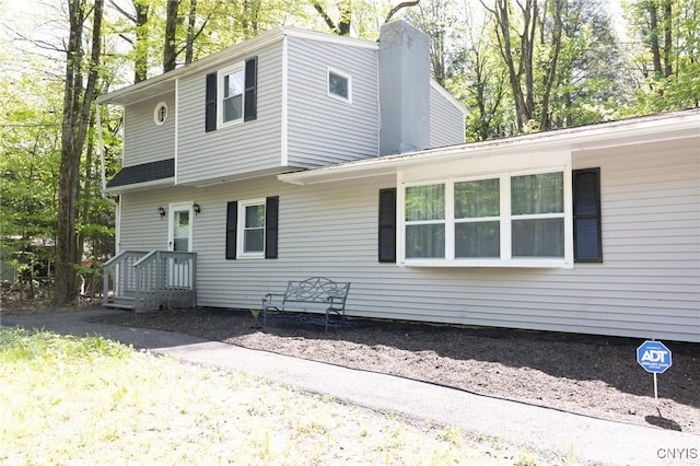 view of property exterior featuring a chimney