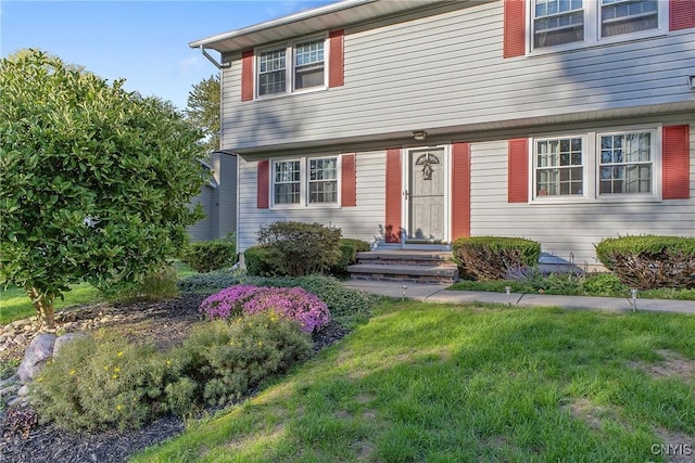 colonial home with a front lawn