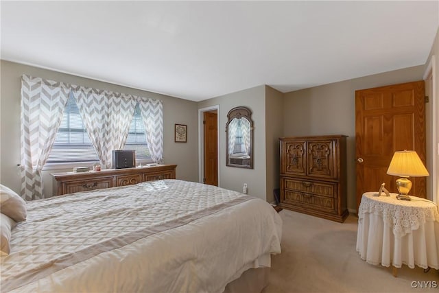 bedroom featuring light carpet