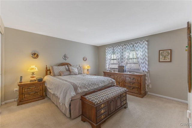 bedroom featuring light colored carpet and baseboards