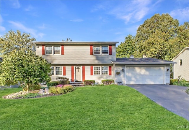 colonial inspired home featuring a garage, asphalt driveway, and a front lawn