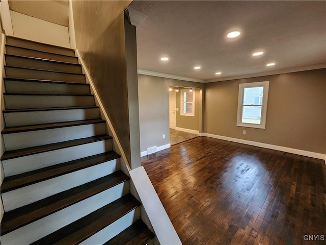 staircase featuring ornamental molding, baseboards, wood finished floors, and recessed lighting