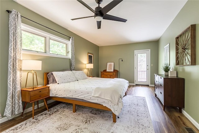 bedroom featuring access to outside, dark wood-style flooring, baseboards, and ceiling fan