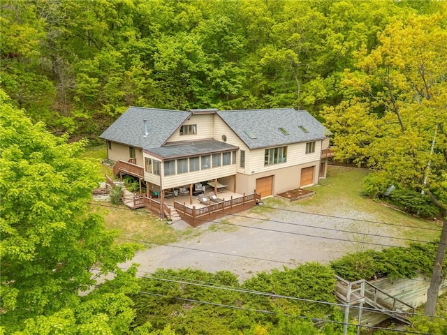 aerial view of property and surrounding area with a heavily wooded area