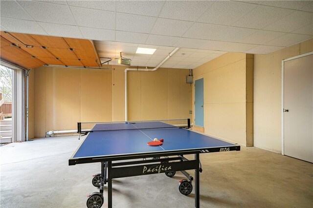 recreation room featuring unfinished concrete flooring