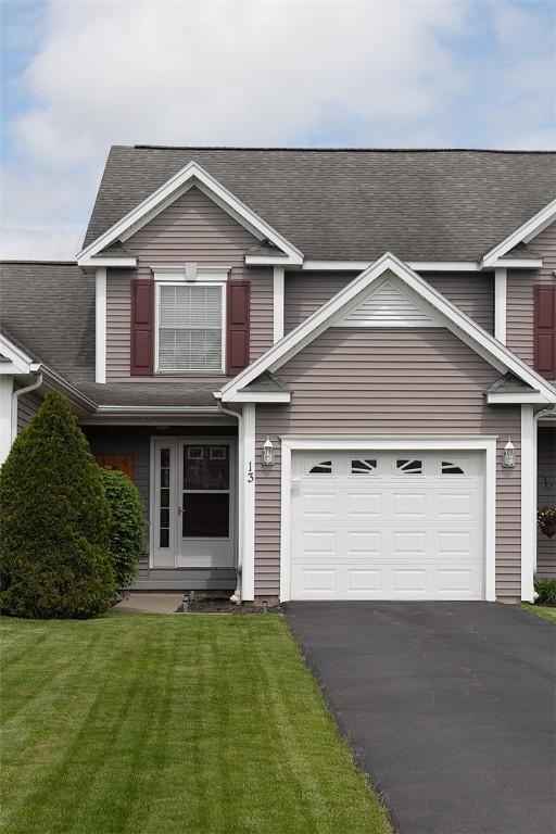 13 Hawthorn Cir, Geneseo, NY 14454 - traditional home featuring driveway, a shingled roof, and a front yard