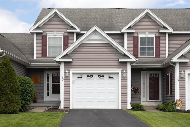 13 Hawthorn Cir, Geneseo, NY 14454 - traditional-style home featuring driveway, a shingled roof, a garage, and a front lawn