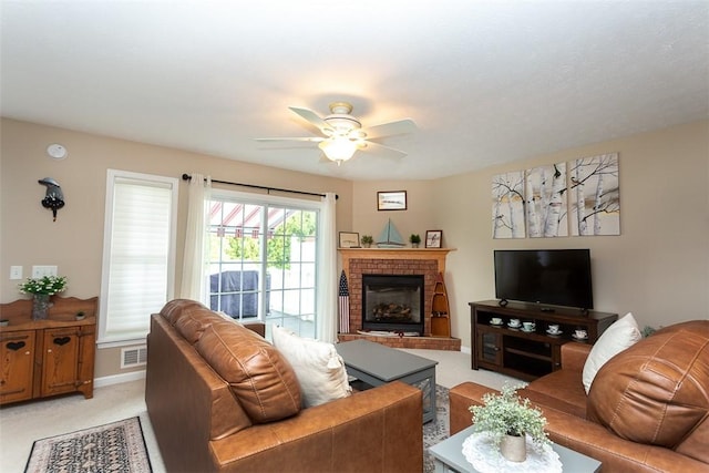 13 Hawthorn Cir, Geneseo, NY 14454 - living area with light carpet, a ceiling fan, a fireplace, and baseboards