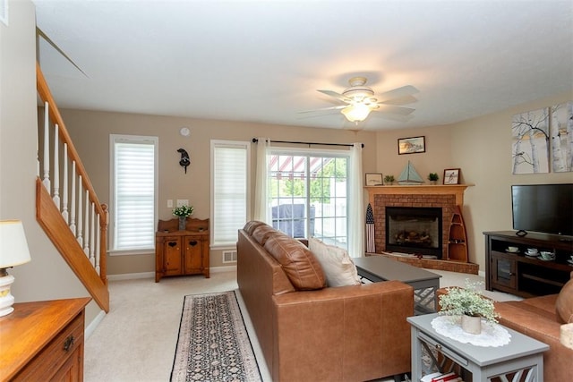 13 Hawthorn Cir, Geneseo, NY 14454 - living room featuring stairs, light carpet, a fireplace, a ceiling fan, and baseboards