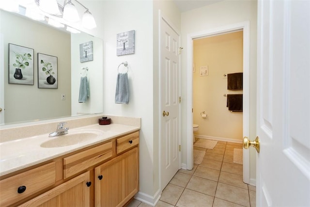 13 Hawthorn Cir, Geneseo, NY 14454 - bathroom with toilet, tile patterned flooring, vanity, and baseboards