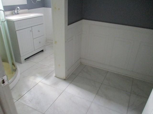 4 Main St, Barton, NY 14859 - bathroom with a shower stall, a wainscoted wall, vanity, a decorative wall, and marble finish floors