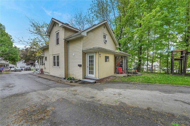 view of side of home with entry steps