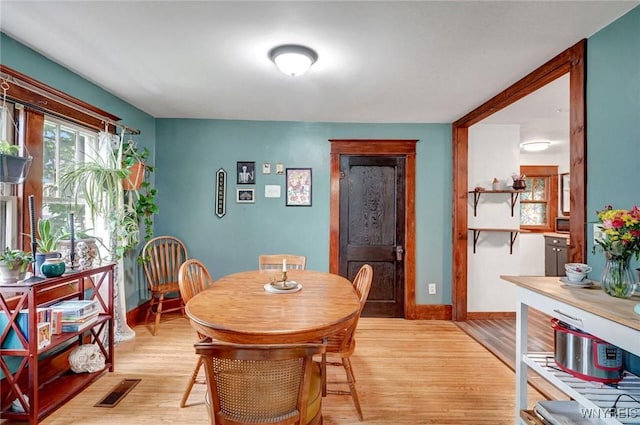 dining room with light wood-style flooring and baseboards