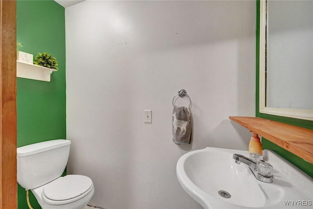 half bath with a sink and toilet