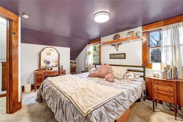 carpeted bedroom featuring vaulted ceiling