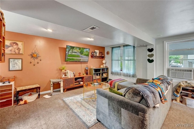 carpeted living area with cooling unit and baseboards