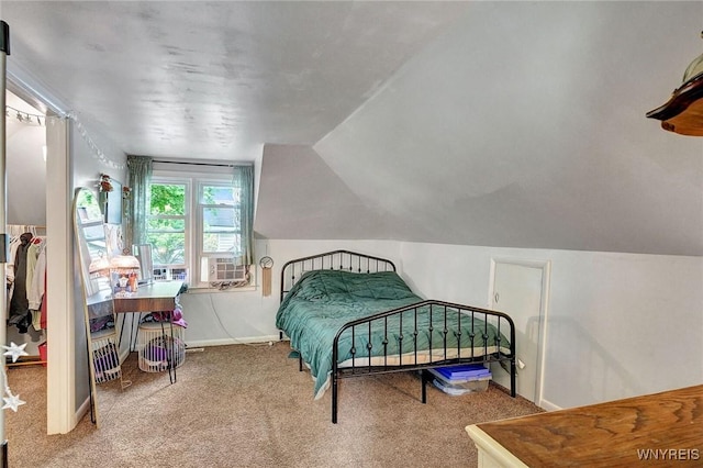 carpeted bedroom featuring lofted ceiling