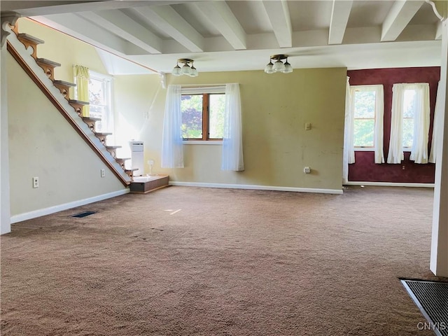 62 Pleasant Valley Rd, Groton, NY 13073 - unfurnished living room featuring beam ceiling, stairs, healthy amount of natural light, baseboards, and carpet
