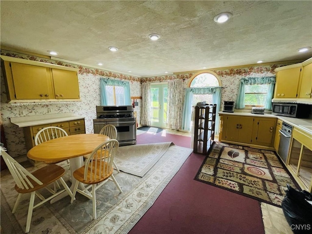 62 Pleasant Valley Rd, Groton, NY 13073 - kitchen with wallpapered walls, appliances with stainless steel finishes, light countertops, a textured ceiling, and crown molding