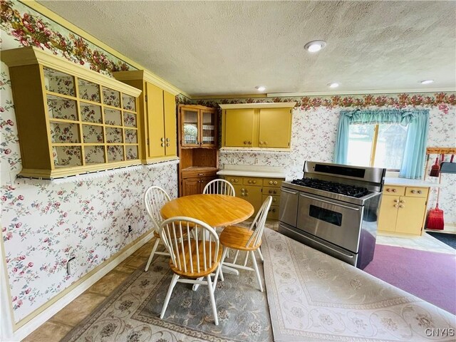 62 Pleasant Valley Rd, Groton, NY 13073 - kitchen featuring double oven range, wallpapered walls, a textured ceiling, crown molding, and light countertops