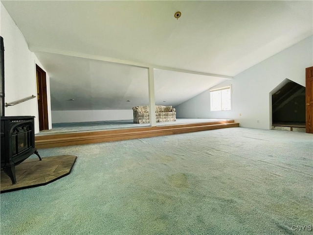 62 Pleasant Valley Rd, Groton, NY 13073 - unfurnished living room featuring a wood stove, carpet, and lofted ceiling