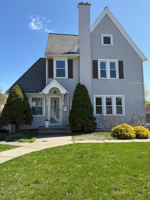 34 Sunnyside Dr, Elmira, NY 14905 - view of front of property with a front lawn, a chimney, and roof with shingles