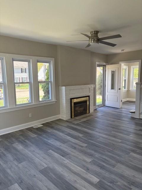34 Sunnyside Dr, Elmira, NY 14905 - unfurnished living room with healthy amount of natural light, baseboards, and dark wood-type flooring