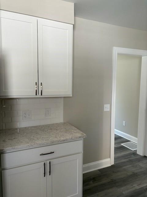 34 Sunnyside Dr, Elmira, NY 14905 - bar featuring dark wood-type flooring, baseboards, and backsplash