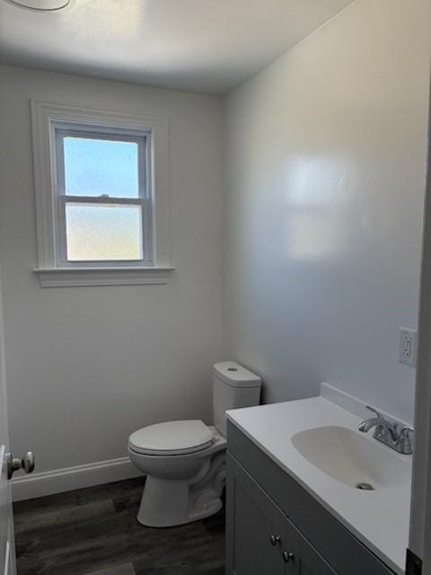 34 Sunnyside Dr, Elmira, NY 14905 - half bathroom featuring vanity, toilet, baseboards, and wood finished floors