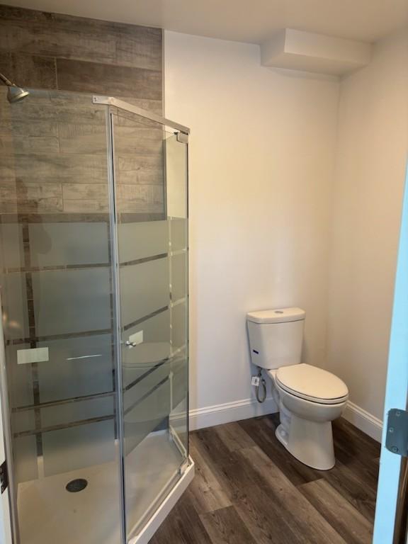 34 Sunnyside Dr, Elmira, NY 14905 - bathroom with toilet, a stall shower, wood finished floors, and baseboards