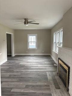 34 Sunnyside Dr, Elmira, NY 14905 - unfurnished living room with ceiling fan, plenty of natural light, a fireplace, and baseboards