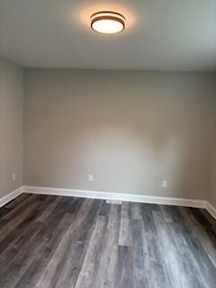 34 Sunnyside Dr, Elmira, NY 14905 - unfurnished room with baseboards and dark wood-style flooring