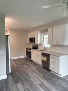 34 Sunnyside Dr, Elmira, NY 14905 - kitchen featuring appliances with stainless steel finishes, a ceiling fan, white cabinetry, and dark wood-style floors