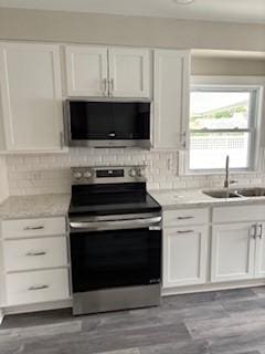 34 Sunnyside Dr, Elmira, NY 14905 - kitchen featuring stainless steel appliances, a sink, white cabinetry, backsplash, and dark wood-style flooring