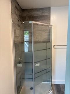 34 Sunnyside Dr, Elmira, NY 14905 - full bathroom with a shower stall, baseboards, and wood finished floors