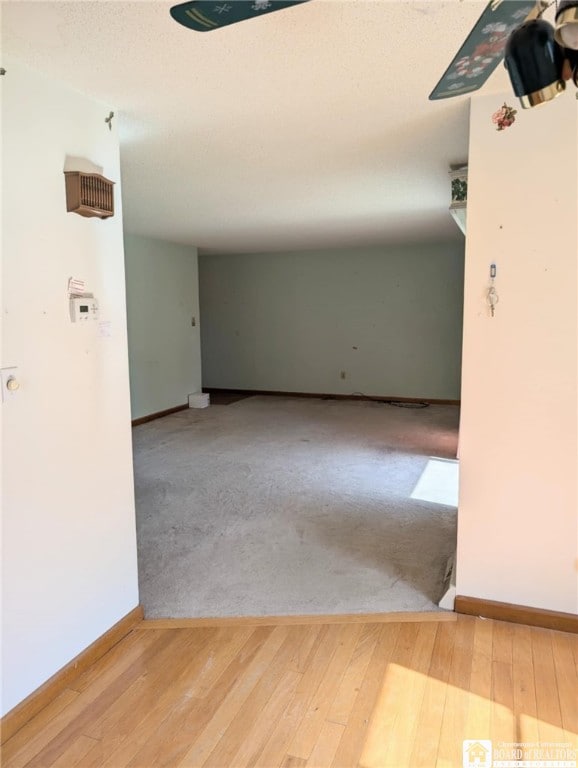 empty room featuring baseboards and wood finished floors