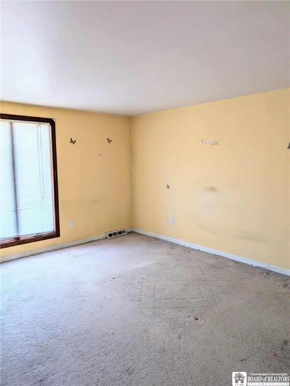 empty room with carpet and baseboards