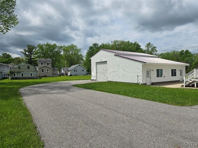 343 N Peterboro St, Lenox, NY 13032 - view of property exterior featuring driveway, an outbuilding, a yard, and metal roof