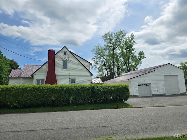 343 N Peterboro St, Lenox, NY 13032 - view of property exterior with a garage, a chimney, and an outbuilding
