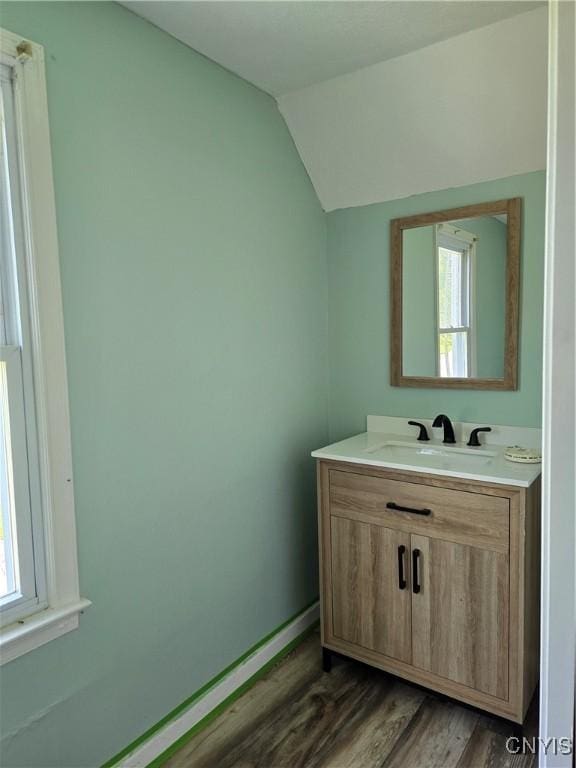 343 N Peterboro St, Lenox, NY 13032 - bathroom featuring wood finished floors, vaulted ceiling, vanity, and baseboards