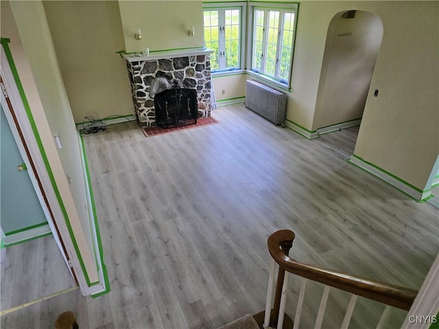 343 N Peterboro St, Lenox, NY 13032 - living area with radiator, wood finished floors, a fireplace, and baseboards