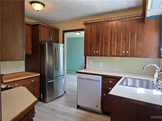 343 N Peterboro St, Lenox, NY 13032 - kitchen with freestanding refrigerator, white dishwasher, a sink, light countertops, and a textured ceiling