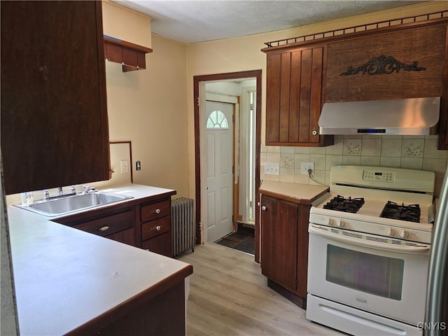 343 N Peterboro St, Lenox, NY 13032 - kitchen featuring white range with gas cooktop, radiator heating unit, ventilation hood, a sink, and light wood finished floors
